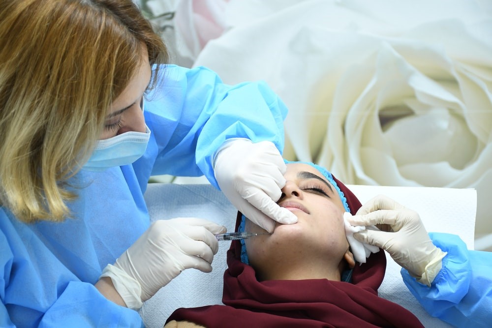 A woman getting Botox injections for firmer and smoother skin